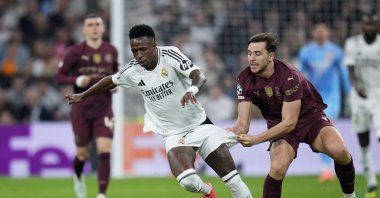 Manchester City's Nico Gonzalez (R) pulls the shorts of Real Madrid's Vinicius Junior during the Champions League playoff second-leg match at Santiago Bernabeu Stadium, Madrid, Spain, Feb. 19, 2025. (AP Photo)