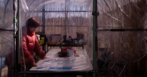 Tomoko Kobayashi looks at a color-coded map of radiation levels created by local residents during an interview near a radiation monitoring lab, Odaka, Japan, Feb. 13, 2026. (AP Photo)