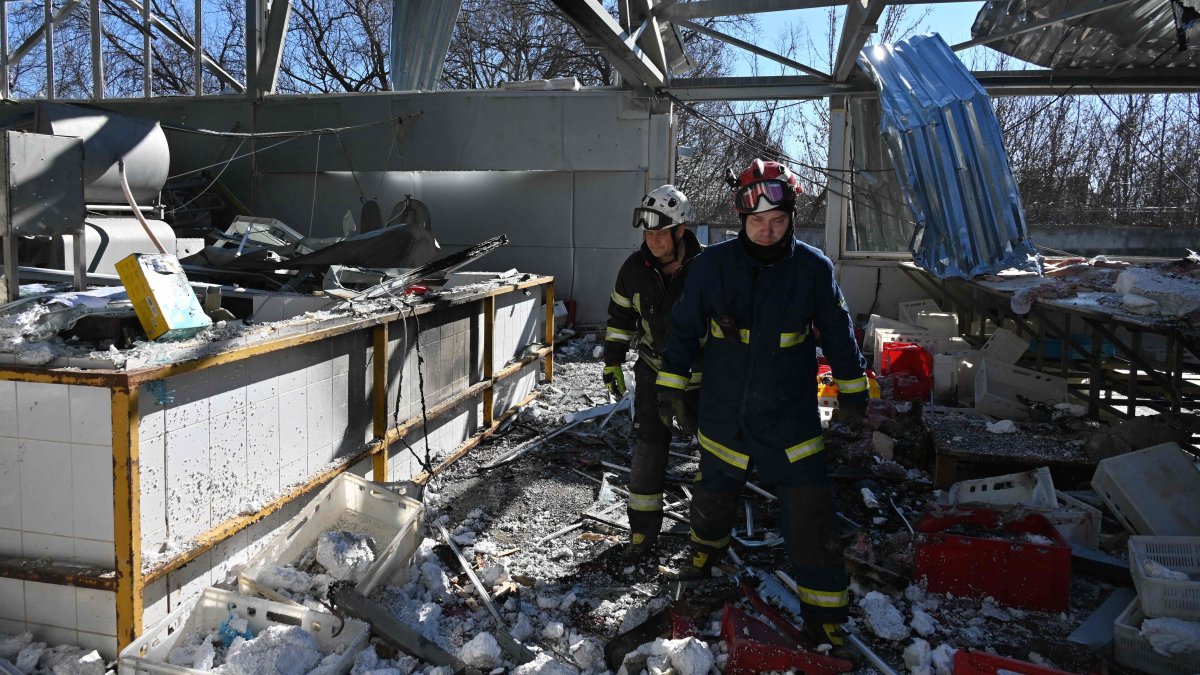 Ukrainian emergency personnel clear debris in a damaged building of a civilian enterprise following a Russian attack in Kharkiv, Ukraine, March 11, 2026. (AFP Photo)