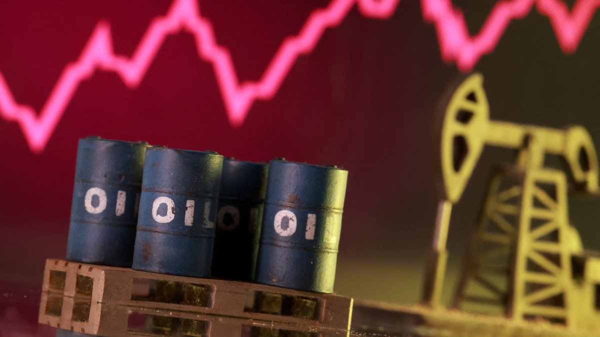 A 3D-printed oil pump jack and barrels in front of a rising stock graph appear in this illustration, March 2, 2026. (Reuters Photo)