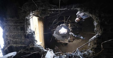 A Palestinian man looks at damage which according to residents was caused by fragments of an intercepted Iranian rocket that landed on a three-story building in the West Bank town of Bidya, west of Salfit, Palestine, March 11, 2026. (AFP Photo)