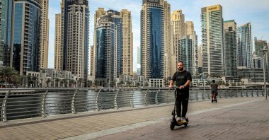 A man rides a scooter at the Dubai Marina in Dubai, UAE, March 11, 2026. (AFP Photo) 