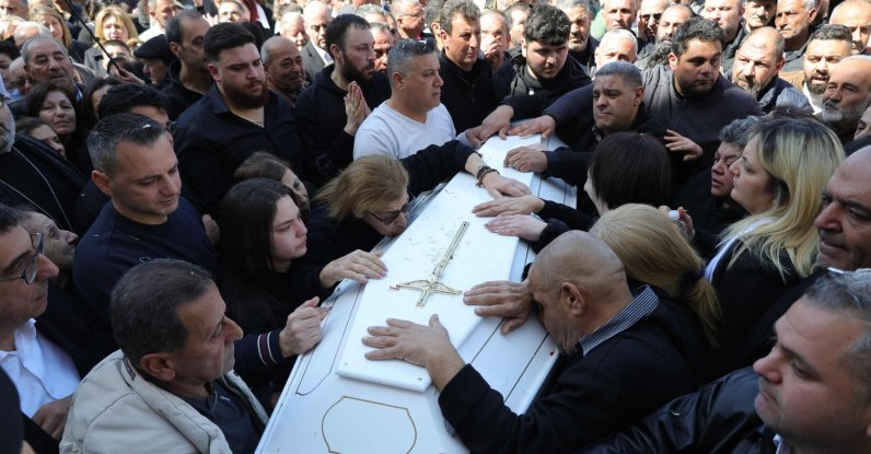 Residents of the Christian Lebanese border village of Qlayaa mourn over the coffin of their village's priest, Father Pierre al-Rahi during his funeral, Lebanon, March 11, 2026. (AFP Photo)