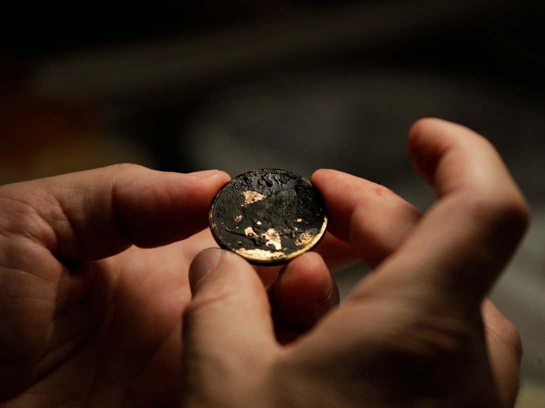 California Gold Marketing Group's Dwight Manley examines a gold coin, recovered from the S.S. Central America steamship that went down in a hurricane in 1857, in a laboratory, Santa Ana, California, U.S., Jan. 23, 2018. (AP Photo)