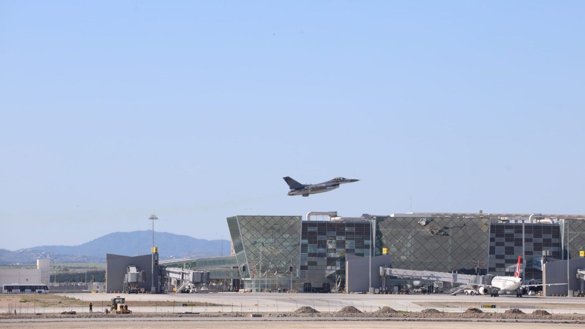 A Turkish F-16 fighter jet flies over an airport building, TRNC, March 9, 2026. (AA Photo)