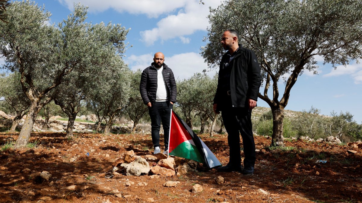 Mousa and Omar Hamayel, both 39, stand near bloodstains at the site where Thaer Hamayel was killed during an attack by Israeli settlers on the Palestinians in the village of Abu Falah near Ramallah, in the Israeli-occupied West Bank, Palestine, March 9, 2026. (Reuters Photo)