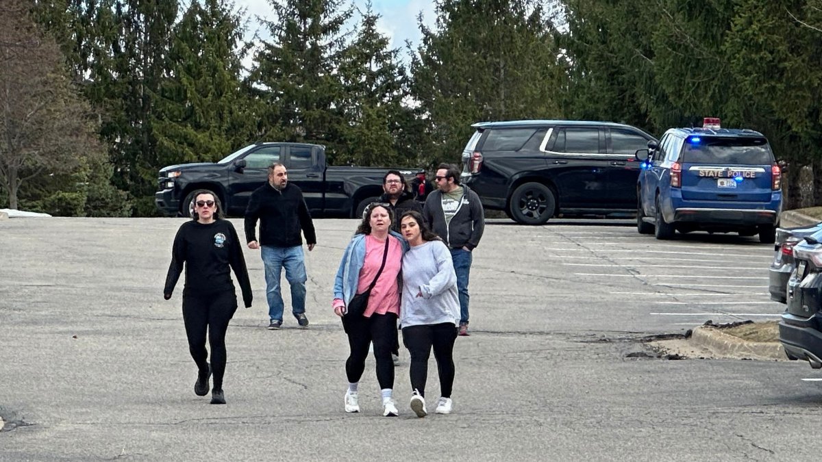 People gather near Temple Israel synagogue in West Bloomfield Township, Mich. (AP Photo)