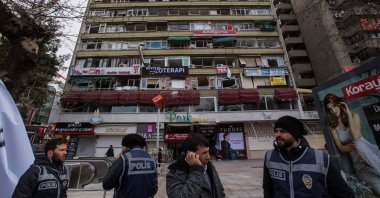 Police block the entrance to the area in front of the PKK bombing scene, under a building devastated by the blast, Kızılay Square, Çankaya, Türkiye, March 15, 2016. (AP Photo)
