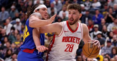 Houston Rockets' Alperen Şengün (R) drives against Denver Nuggets' Aaron Gordon during the second half at Ball Arena, Denver, U.S., March 11, 2026. (AFP Photo)