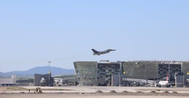 A Turkish F-16 fighter jet flies over an airport building, TRNC, March 9, 2026. (AA Photo)