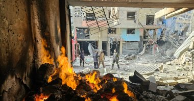 Firefighters work at the site of overnight Israeli airstrikes in the Haret Hreik neighborhood of Beirut’s southern suburbs on March 12, 2026. (AFP Photo)