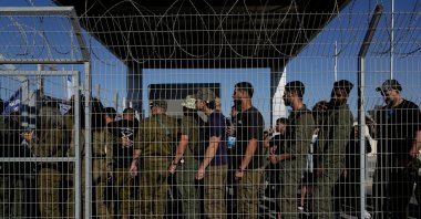 Israeli soldiers gather at the gate to the Sde Teiman military base, as people protest in support of soldiers being questioned for detainee abuse, July 29, 2024. (AP File Photo)