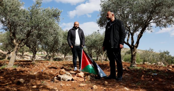 Mousa and Omar Hamayel, both 39, stand near bloodstains at the site where Thaer Hamayel was killed during an attack by Israeli settlers on the Palestinians in the village of Abu Falah near Ramallah, in the Israeli-occupied West Bank, Palestine, March 9, 2026. (Reuters Photo)