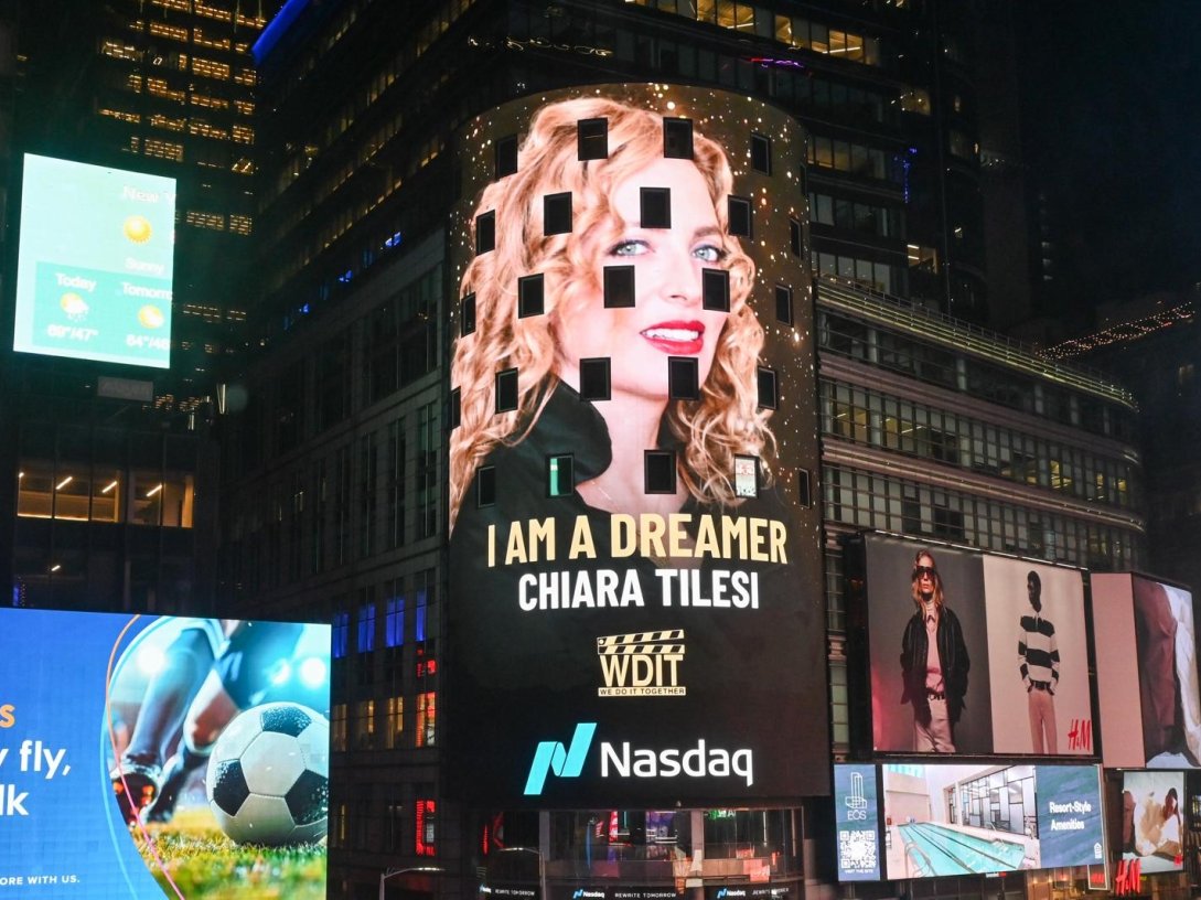 Chiara Tilesi, founder of "We Do It Together," is featured on a digital billboard in Times Square, New York, U.S., March 8, 2026. (Photo Courtesy of We Do It Together)