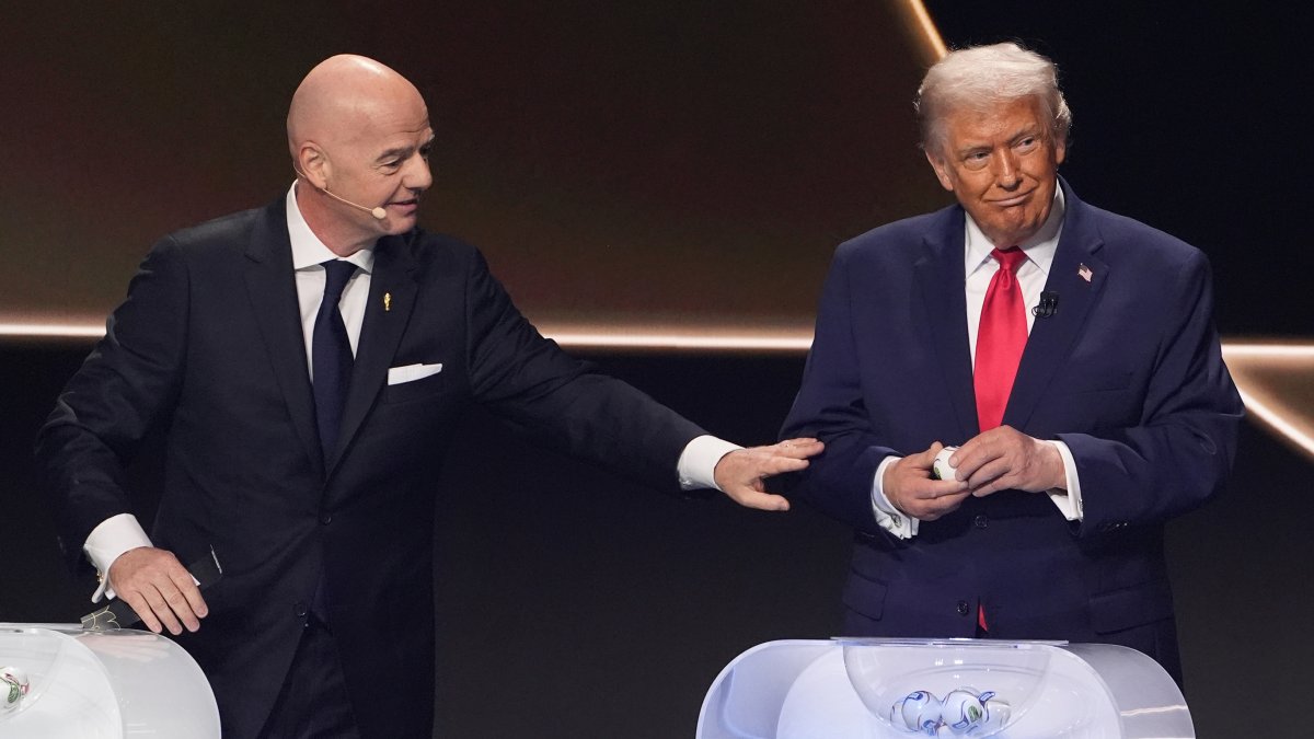 FIFA President Gianni Infantino (L) pauses with President Donald Trump, right, during the draw for the 2026 World Cup at the Kennedy Center, Washington, U.S., Dec. 5, 2025. (AP Photo)
