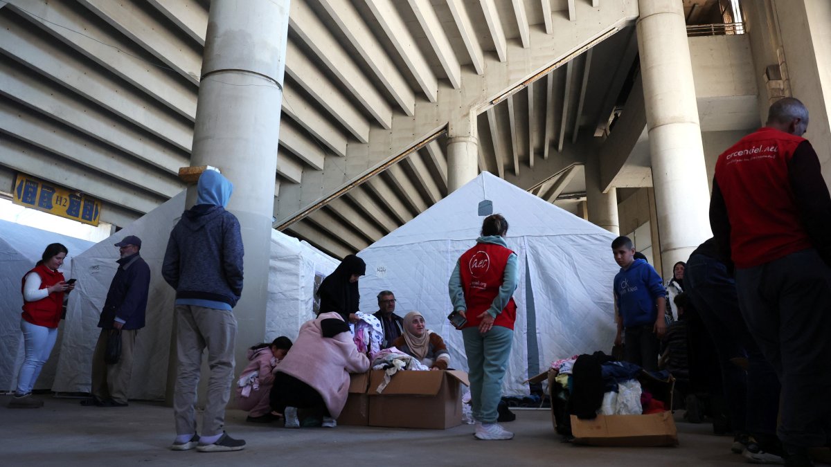 Displaced people look for clothes as they shelter in a stadium, following an escalation between Hezbollah and Israel amid the U.S.-Israeli conflict with Iran, Beirut, Lebanon, March 9, 2026. (Reuters Photo)