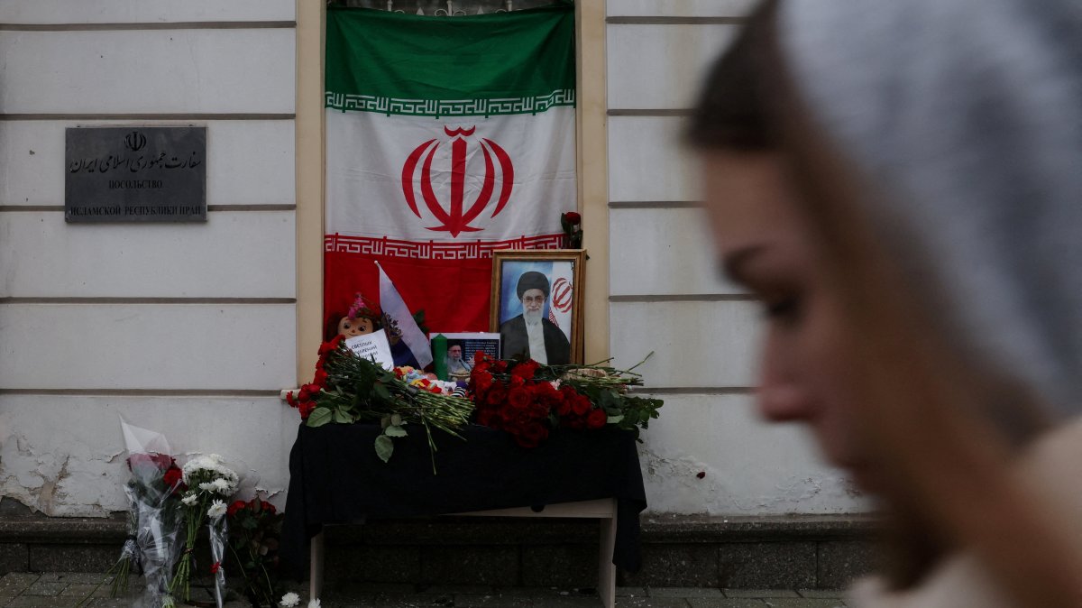 A portrait of late Iran's Supreme Leader Ayatollah Ali Khamenei, who was killed in U.S. and Israeli strikes on Saturday, stands among flowers outside the Iranian Embassy in Moscow, Russia, March 1, 2026. (Reuters Photo)