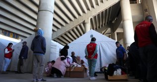 Displaced people look for clothes as they shelter in a stadium, following an escalation between Hezbollah and Israel amid the U.S.-Israeli conflict with Iran, Beirut, Lebanon, March 9, 2026. (Reuters Photo)