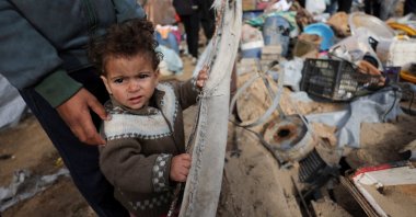A Palestinian child stands at the site of an Israeli strike on a tent camp sheltering displaced people, Gaza City, Palestine, March 12, 2026. (Reuters Photo)