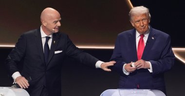 FIFA President Gianni Infantino (L) pauses with President Donald Trump, right, during the draw for the 2026 World Cup at the Kennedy Center, Washington, U.S., Dec. 5, 2025. (AP Photo)