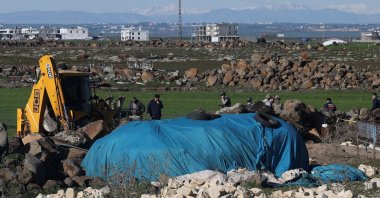 Turkish army personnel search a field after a piece of ammunition fell following the interception of a missile launched from Iran by a NATO air defense system, Diyarbakır, Türkiye, March 9, 2026. (Reuters Photo)