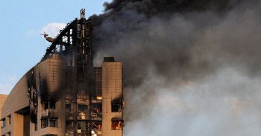 Smoke rises from a high-rise building following a drone attack in Kuwait City, Kuwait, March 8, 2026. (AFP Photo)