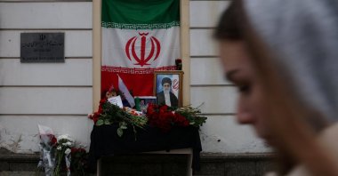 A portrait of late Iran's Supreme Leader Ayatollah Ali Khamenei, who was killed in U.S. and Israeli strikes on Saturday, stands among flowers outside the Iranian Embassy in Moscow, Russia, March 1, 2026. (Reuters Photo)