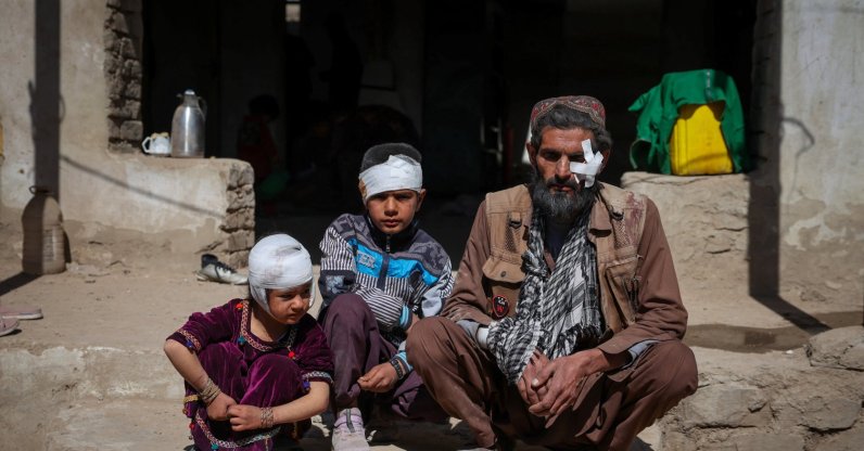 Mohammad Feraidoon, his son Aqeel and daughter Nazanin, who were injured in what the Taliban said was a Pakistani air strike, sit outside their damaged house on the outskirts of Kabul, Afghanistan, March 13, 2026. (Reuters Photo)