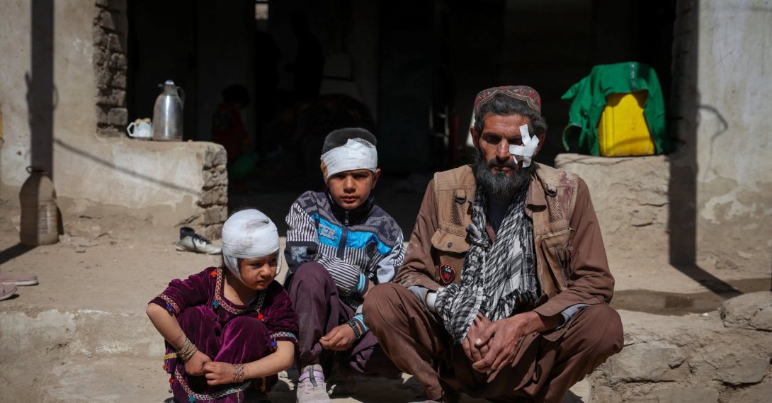 Mohammad Feraidoon, his son Aqeel and daughter Nazanin, who were injured in what the Taliban said was a Pakistani air strike, sit outside their damaged house on the outskirts of Kabul, Afghanistan, March 13, 2026. (Reuters Photo)