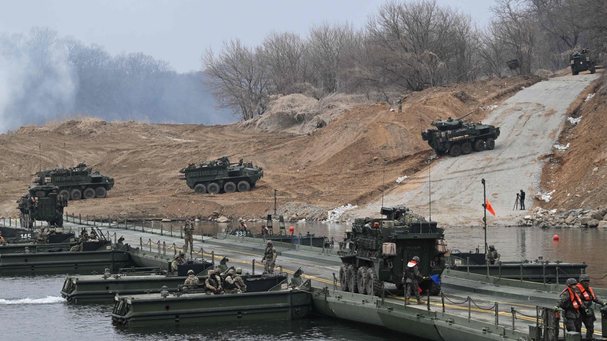 U.S. Stryker infantry carrier vehicles cross a river over a floating bridge as they participate in a combined maneuver training with wet gap crossing during the 2026 South Korea-U.S. Freedom Shield military exercise in Yeoncheon, South Korea, March 14, 2026. (AFP Photo)