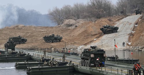U.S. Stryker infantry carrier vehicles cross a river over a floating bridge as they participate in a combined maneuver training with wet gap crossing during the 2026 South Korea-U.S. Freedom Shield military exercise in Yeoncheon, South Korea, March 14, 2026. (AFP Photo)