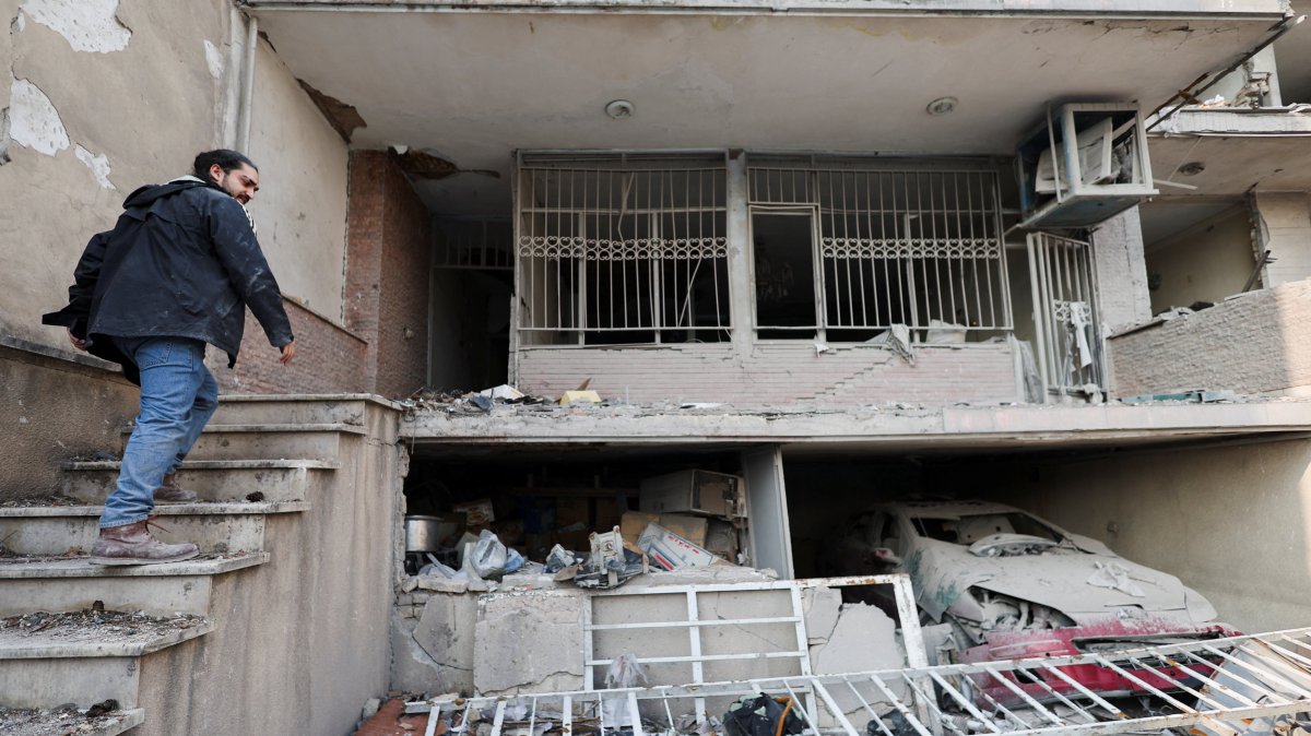 An Iranian man, Parsa, goes into his house, which was destroyed by a strike, amid the U.S.-Israeli conflict with Iran, Tehran, Iran, March 14, 2026. (Reuters Photo)