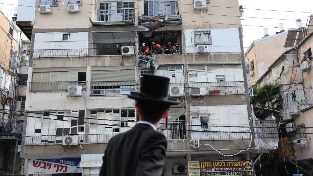 An Ultra Orthodox Jewish man looks on as Israeli rescuers work at the scene of an Iranian strike in Tel Aviv, Israel, March 15, 2026. (EPA Photo)