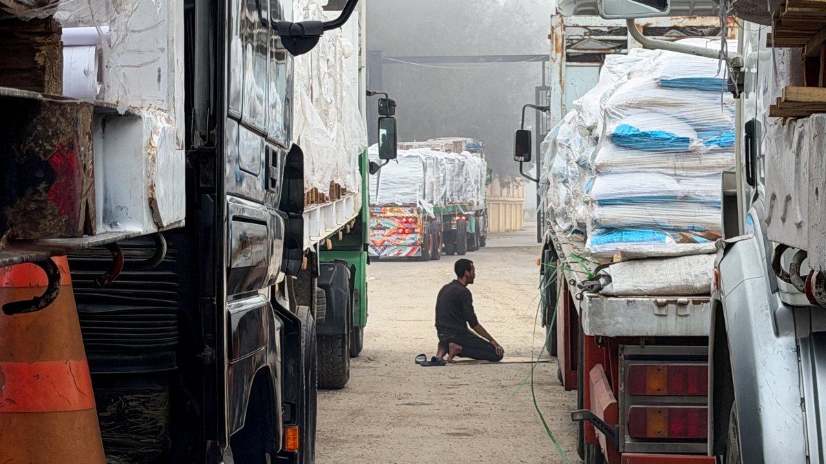 An Egyptian man prays next to trucks carrying humanitarian aid and fuel lined up at the Rafah border to cross into the Gaza Strip, on the Egyptian side, in Rafah, Egypt, Feb. 10, 2026. (Reuters Photo)