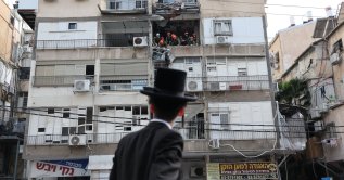 An Ultra Orthodox Jewish man looks on as Israeli rescuers work at the scene of an Iranian strike in Tel Aviv, Israel, March 15, 2026. (EPA Photo)