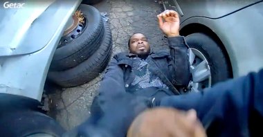 In this photo taken from video released by the Bridgeport Police Department, Dyshan Best looks up at Bridgeport Police officer Yoon Heo after being shot by Heo during a chase, Bridgeport, Conn., U.S., March 31, 2025. (AP Photo)