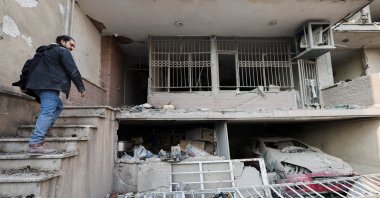 An Iranian man, Parsa, goes into his house, which was destroyed by a strike, amid the U.S.-Israeli conflict with Iran, Tehran, Iran, March 14, 2026. (Reuters Photo)
