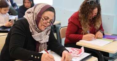 Yüksel (L) and Zeliha Boğaakça attend a literacy class together, practicing reading and writing, Şanlıurfa, Türkiye, March 15, 2026. (AA Photo) 