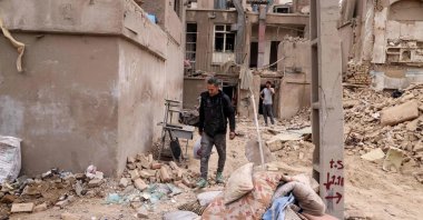 An Iranian collects his belongings from destroyed buildings following a military strike on the capital Tehran, Iran, March 15, 2026. (AFP Photo)