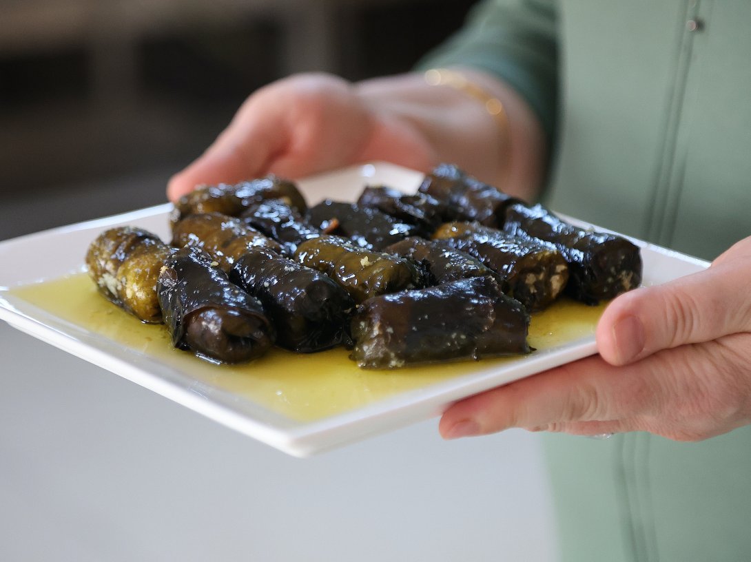 A cook displays lor dolması, a traditional dish made with evelik leaves stuffed with curd cheese and bulgur, Kayseri, central Türkiye, March 14, 2026. (AA Photo)