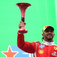 Ferrari's Lewis Hamilton celebrates on the podium with his trophy after finishing third in the Chinese Grand Prix at Shanghai International Circuit, Shanghai, China, March 15, 2026. (Reuters Photo)
