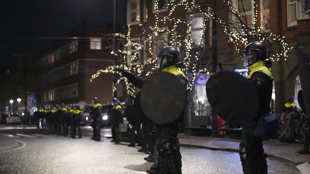 Dutch riot police break up a gathering of Morocco fans after fireworks were thrown when celebrating their team's victory against Spain, Amsterdam, Netherlands, Dec. 6, 2022. (AP Photo)