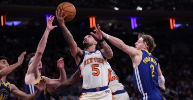 New York Knicks' Jose Alvarado attempts a layup defended by Golden State Warriors' Brandin Podziemski during the fourth quarter at Madison Square Garden, New York City, U.S., March 15, 2026. (AFP Photo)
