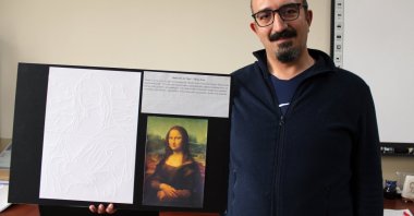 Cahit Şahin displays a tactile version of the Mona Lisa for visually impaired students, Aksaray, Türkiye, March 16, 2026. (DHA Photo)