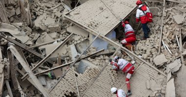 Emergency personnel work at the site of a building destroyed in an Israeli strike, in Tehran, Iran, March 16, 2026. (Reuters Photo)