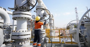A worker operates valves at the Rumaila oil field, as the country cuts nearly 1.5 million barrels per day of output amid halted exports following the closure of the Strait of Hormuz, in Basra, Iraq, March 4, 2026. (Reuters Photo)