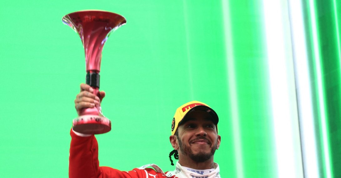 Ferrari's Lewis Hamilton celebrates on the podium with his trophy after finishing third in the Chinese Grand Prix at Shanghai International Circuit, Shanghai, China, March 15, 2026. (Reuters Photo)
