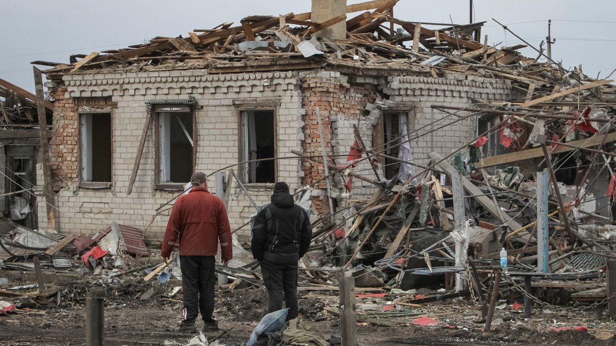 Residents stand at the site of a Russian missile strike, amid Russia's attack on Ukraine, village of Zaitseve, Dnipropetrovsk region, Ukraine, March 16, 2026. (Reuters Photo)