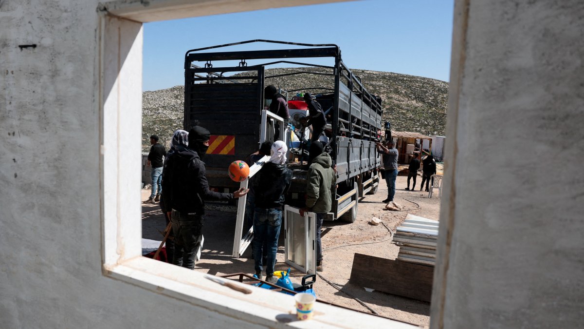 Members of a Palestinian Bedouin community prepare to leave following Israeli settler violence, in Al Mughayyir, near Ramallah, in the Israeli-occupied West Bank, Palestine, Feb. 21, 2026. (Reuters Photo)