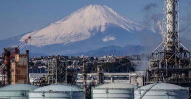 This picture shows tanks at an oil refinery as Mount Fuji looms in the background in Yokohama, Kanagawa Prefecture, Japan, Feb. 9, 2025. (AFP Photo)